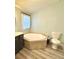 The bathroom features a corner tub for relaxation and tiled flooring at 5306 Empire Church Rd, Groveland, FL 34736