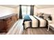 Inviting bedroom with sloped ceiling, dresser, and two windows with wooded view at 5306 Empire Church Rd, Groveland, FL 34736