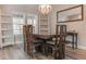 View of dining room with wood table and chairs, chandelier and large window at 5306 Empire Church Rd, Groveland, FL 34736