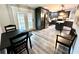 The eat-in kitchen features dark cabinets, stainless steel appliances, and a view to the back yard at 5306 Empire Church Rd, Groveland, FL 34736