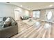 Bright living room with hardwood floors, modern decor, piano, and natural light at 5306 Empire Church Rd, Groveland, FL 34736