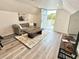 Relaxing living room with comfortable seating, a TV, and access to outdoor deck at 5306 Empire Church Rd, Groveland, FL 34736