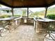 Outdoor kitchen with stone countertops and a stainless steel grill at 5306 Empire Church Rd, Groveland, FL 34736