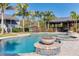 Beautiful pool and spa area with lush landscaping, fire pit, and outdoor kitchen perfect for entertaining at 5306 Empire Church Rd, Groveland, FL 34736