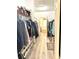 View of walk-in closet with built-in shelving, hanging rods, and view into bathroom at 5306 Empire Church Rd, Groveland, FL 34736