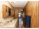 Bathroom with a vanity and wood paneled walls at 55634 Sam St, Astor, FL 32102