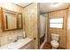 Full bathroom boasts vintage floral wallpaper, a sink with vanity, shower and toilet at 55634 Sam St, Astor, FL 32102