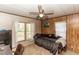 Bedroom featuring a ceiling fan, desk, two windows, and comfortable seating at 55634 Sam St, Astor, FL 32102