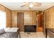 Wood paneled bedroom is complete with a closet, interior door, and modern TV on a carpeted floor at 55634 Sam St, Astor, FL 32102