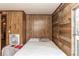 Simple bedroom with wood paneled walls at 55634 Sam St, Astor, FL 32102
