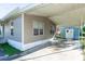 Tan home featuring a carport and storage shed in the back at 55634 Sam St, Astor, FL 32102