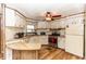 A well-equipped kitchen featuring wood floor, white cabinets, and modern appliances for a functional cooking space at 55634 Sam St, Astor, FL 32102