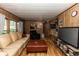 Inviting living room featuring wood paneled walls and comfortable seating at 55634 Sam St, Astor, FL 32102