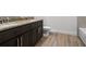 Bathroom with double vanity with granite countertops and wood-look tile floor at 559 Coronado Cove Rd, New Smyrna Beach, FL 32168