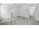 Bedroom with neutral walls and soft gray carpeting and multiple doorways leading to other rooms at 559 Coronado Cove Rd, New Smyrna Beach, FL 32168