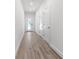 Hallway featuring luxury flooring, neutral colored walls, and multiple doors and access to entry at 559 Coronado Cove Rd, New Smyrna Beach, FL 32168