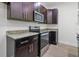 Kitchen featuring dark wood cabinets, stainless steel appliances and granite countertops at 559 Coronado Cove Rd, New Smyrna Beach, FL 32168