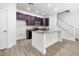 Kitchen featuring an island, dark wood cabinets, stainless steel appliances and stair access at 559 Coronado Cove Rd, New Smyrna Beach, FL 32168