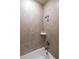 Tiled shower features sleek fixtures and corner shelf at 559 Coronado Cove Rd, New Smyrna Beach, FL 32168