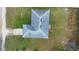 Aerial view showcases the roof of the house surrounded by green grass at 599 S Cedar Ave, Orange City, FL 32763