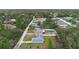 Aerial view of the neighborhood showing a green pool in the backyard at 599 S Cedar Ave, Orange City, FL 32763
