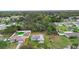 Neighborhood aerial view featuring a home with a fenced in green pool in the backyard at 599 S Cedar Ave, Orange City, FL 32763