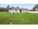 Spacious backyard with lush green lawn and patio, perfect for outdoor activities at 599 S Cedar Ave, Orange City, FL 32763