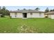 Spacious backyard with lush green lawn and patio, perfect for outdoor activities at 599 S Cedar Ave, Orange City, FL 32763