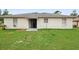 Spacious backyard with lush green lawn and patio, ideal for outdoor activities at 599 S Cedar Ave, Orange City, FL 32763