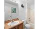 Bathroom features vanity, toilet, and shower, with a window and nautical decor at 599 S Cedar Ave, Orange City, FL 32763