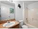 Bathroom features vanity, toilet, and shower, with a window and nautical decor at 599 S Cedar Ave, Orange City, FL 32763
