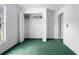 Bright bedroom with green carpet, a window view, and a closet for storage at 599 S Cedar Ave, Orange City, FL 32763