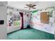 Unique bedroom with creative wall decor and a ceiling fan at 599 S Cedar Ave, Orange City, FL 32763