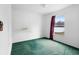 Simple bedroom with green carpet and natural light at 599 S Cedar Ave, Orange City, FL 32763