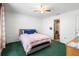 Bedroom features ceiling fan and bed, with ensuite bathroom for convenience at 599 S Cedar Ave, Orange City, FL 32763