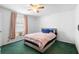Bedroom features ceiling fan and bed, with window view and natural light at 599 S Cedar Ave, Orange City, FL 32763
