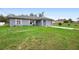 A lovely single-Gathering home with a well-manicured lawn and a classic gray exterior design at 599 S Cedar Ave, Orange City, FL 32763