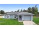 Charming single-story home with a well-maintained front yard and a one-car garage at 599 S Cedar Ave, Orange City, FL 32763