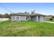 Quaint single-Gathering home with a gray exterior, manicured lawn, and a welcoming entryway at 599 S Cedar Ave, Orange City, FL 32763
