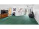 Bright living room featuring vaulted ceilings, a kitchen view, and sliding glass doors to the backyard at 599 S Cedar Ave, Orange City, FL 32763
