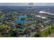 Aerial view of a property with the Creekside Middle School and a picturesque lake in the distance at 6071 Sabal Hammock Cir, Port Orange, FL 32128