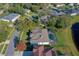 Aerial view of the property showcases the screened pool, backyard, and its location near a tranquil lake at 6071 Sabal Hammock Cir, Port Orange, FL 32128