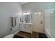 Bright bathroom featuring a white vanity with dark fixtures, a mirror, and a shower at 6071 Sabal Hammock Cir, Port Orange, FL 32128