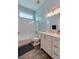 Bathroom featuring a shower-tub combo, and white vanity with cabinets at 6071 Sabal Hammock Cir, Port Orange, FL 32128