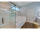 Bathroom featuring a glass shower, soaking tub, and white cabinets at 6071 Sabal Hammock Cir, Port Orange, FL 32128