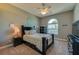 Bedroom featuring neutral tones, an arched window, and ceiling fan at 6071 Sabal Hammock Cir, Port Orange, FL 32128