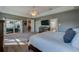 Spacious main bedroom featuring a ceiling fan, gray walls, and access to the outdoor living area at 6071 Sabal Hammock Cir, Port Orange, FL 32128