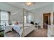 Bedroom featuring a four poster bed, neutral tones, and a ceiling fan at 6071 Sabal Hammock Cir, Port Orange, FL 32128