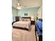 Comfortable bedroom with a ceiling fan, light green walls, and carpet at 6071 Sabal Hammock Cir, Port Orange, FL 32128