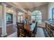 Formal dining room with a large table, columns, and a view of the office at 6071 Sabal Hammock Cir, Port Orange, FL 32128